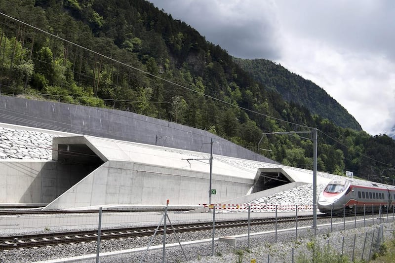 A train runs past at the northern entrance of the Gotthard Base Tunnel on the eve of its inauguration. Laurent Gillieron / EPA