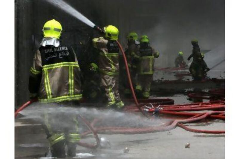 Firefighters tackle a blaze in Dubai last May. Female firefighters may be an idea whose time has come.
