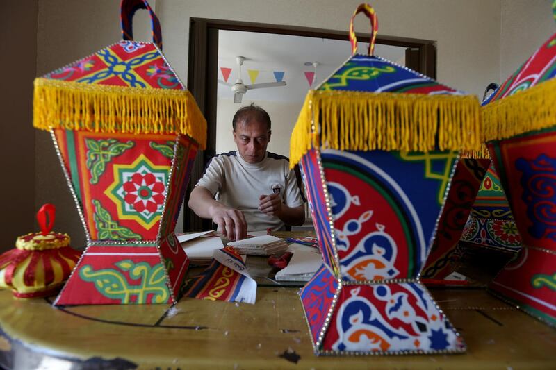 A Palestinian man makes lanterns for sale in preparation for the Muslim holy month of Ramadan, as he confines himself with his family to their home amid concerns about the spread of the coronavirus, in the southern Gaza Strip on April 14, 2020. Reuters