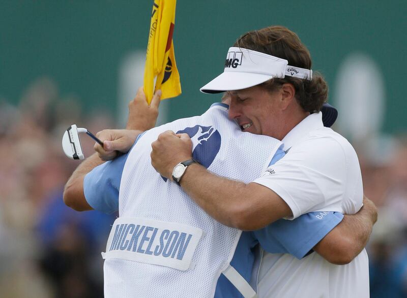 Phil Mickelson of the United States celebrates after his final putt on the 18th green with his caddie Jim Mackay during the final round of the British Open Golf Championship at Muirfield, Scotland, Sunday July 21, 2013. (AP Photo/Jon Super) *** Local Caption ***  British Open Golf.JPEG-02289.jpg