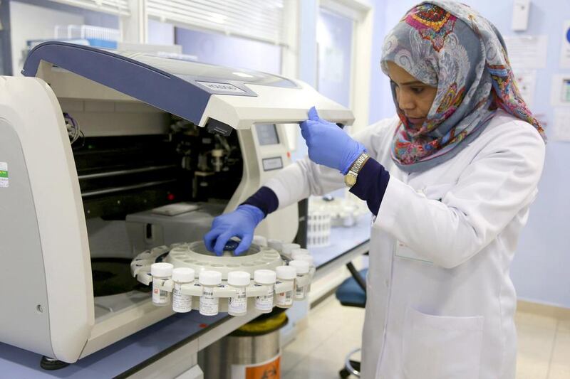 A laboratory technician at work in the histopathology unit of Al Borg Medical Laboratories in Abu Dhabi, where up to 5,000 tests a day are conducted. Irene García León for The National