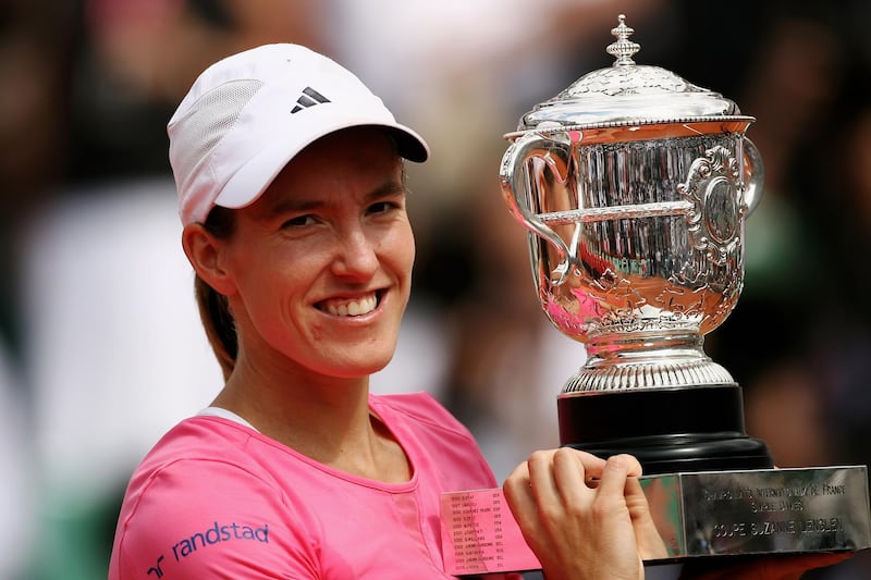 PARIS - JUNE 09:  Justine Henin of Belgium holds the trophy after winning  against Ana Ivanovic of Serbia in the Women's Singles Final on day fourteen of the French Open at Roland Garros on June 9, 2007 in Paris, France.  (Photo by Clive Brunskill/Getty Images)