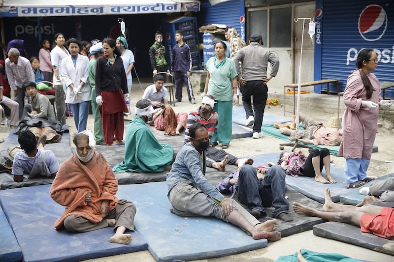Health workers take care of injured people outside the Manmohan Memorial Community Hospital after an earthquake caused serious damage in Kathmandu. Narendra Shrestha / EPA