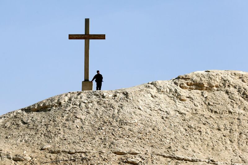 A Jordanian policeman stand next to a giant cross, during the Jordan Catholic church annual pilgrimage, at the Baptism Site, Jordan Valley, some 60km Southwest of Amman, Jordan.  Thousands of Jordanian Catholics headed to the place believed to be where John baptized Jesus Christ in the water of the Jordan River.  EPA