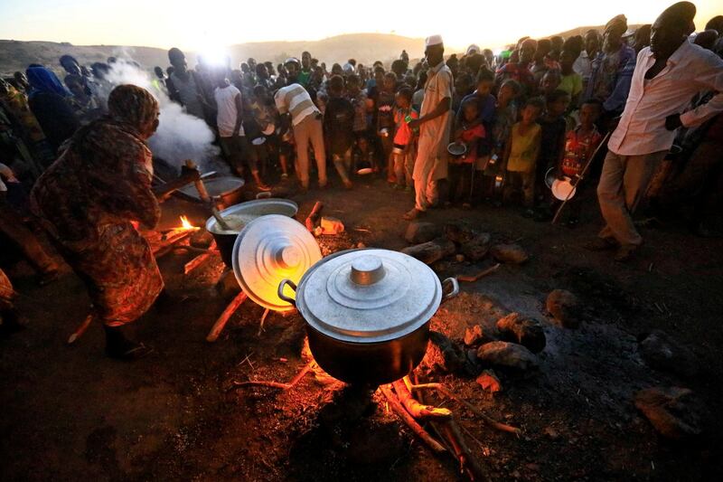 Ethiopian refugees, fleeing the ongoing fighting in Tigray region, wait for food at the Um-Rakoba camp, on the Sudan-Ethiopia border, in the Al-Qadarif state, Sudan. Reuters