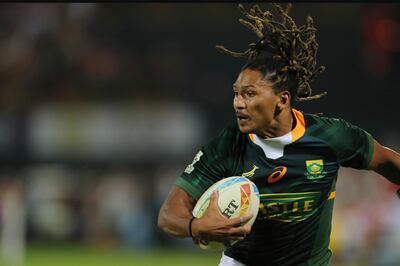 South Africa's Justin Geduld runs with the ball against England during a match of the Emirates Airline Rugby Sevens in Dubai, United Arab Emirates, Friday, Dec.6, 2019. (AP Photo/Kamran Jebreili)