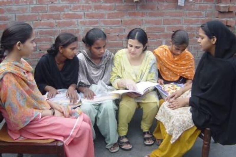 Provided photos Sharjah-based Shazia Kidwai (she's the one in pale yellow who is talking to the girls).  meets with girls from the village of Baragaon in northern IndiaÕs Uttar Pradesh state this month as part of her initiative to get dropouts back into schools and start literacy programmes for girls who have never been to school. Some 20 girls from three Indian villages in KidwaiÕs home state are back in school this month and 16 other girls will begin learning to read and write. Courtesy Shazia Kidwai
