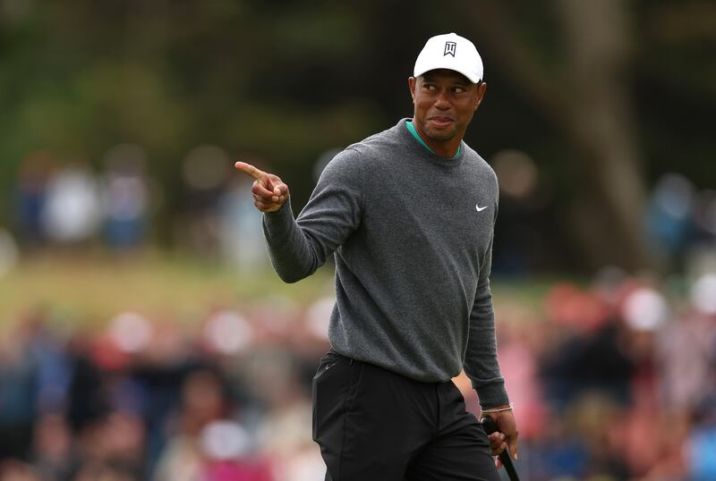 Tiger Woods celebrates a birdie putt at the 17th green. Getty Images