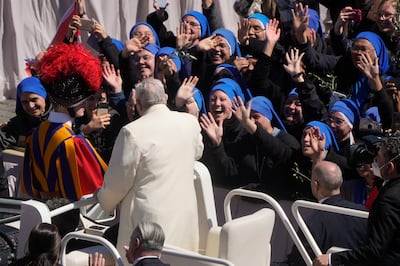 Pope Francis greets the faithful as he leaves after celebrating Palm Sunday Mass in St Peter's Square. AP
