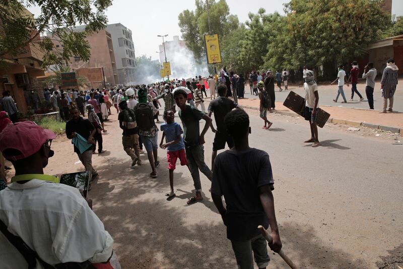 Protesters clash with security forces as they fire tear gas to prevent them from marching towards the presidential palace during demonstrations demanding civilian rule, in Khartoum, Sudan, May 19, 2022. AP Photo