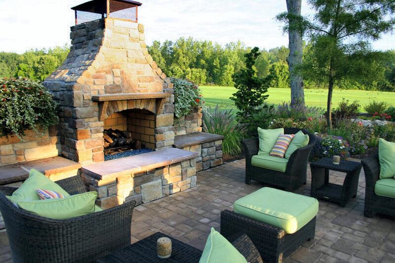 Lounge seating surrounds an outdoor stone-carved fire pit in a gazebo-style nook. 
Toptenrealestatedeals.com