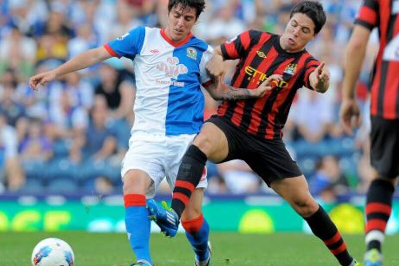 Manchester City's French midfielder Samir Nasri (R) vies with Blackburn Rovers' Argentinian midfielder Mauro Formica (L) during the English Premier League football match between Blackburn Rovers and Manchester City at Ewood Park, Blackburn, north-west England on October 1, 2011. AFP PHOTO/ANDREW YATES

RESTRICTED TO EDITORIAL USE. No use with unauthorized audio, video, data, fixture lists, club/league logos or “live” services. Online in-match use limited to 45 images, no video emulation. No use in betting, games or single club/league/player publications
 *** Local Caption ***  957629-01-08.jpg