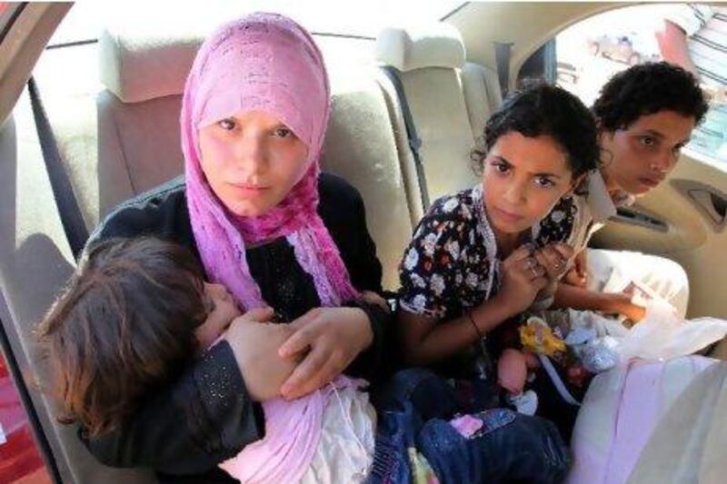 Civilians flee from the besieged city of Bani Walid, Libya, yesterday. According to media sources, Libyan rebels said they were delaying assault on Bani Walid, one of the last bastions of fugitive leader Muammar Qaddafi after meeting fierce resistance. MOHAMMED MESSARA / EPA