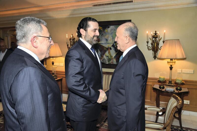 Prime Minister Saad Hariri shakes hands with former rival Ashraf Rifi as the two meet for a public reconciliation with former prime minister Fouad Siniora. Hand out image