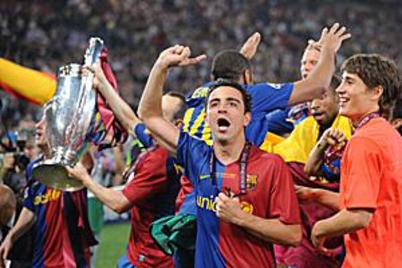 Barcelona´s midfielder Xavi celebrates with teammates after winning the Champions League.