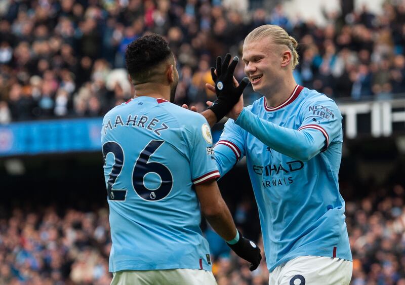 Erling Haaland celebrates with City team-mate Riyad Mahrez after scoring the first goal. EPA