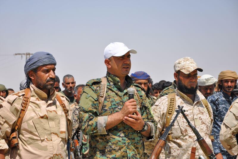 Ahmad Abu Khawlah (C), chief of the Deir Ezzor Military Council (DEMC) -- a coalition of Arab tribes and fighters that belongs to the broader US-backed Syrian Democratic Forces -- attends a press conference by the DEMC in the town of Shadadi, about 60 kilometres (37 miles) south of the northeastern Syrian city of Hassakeh, on August 25, 2017.
The US-backed Arab and Kurdish fighters said on August 25, 2017 that they would launch an offensive "very soon" to oust the Islamic State (IS) group from Syria's oil-rich Deir Ezzor province. 
"Our forces are preparing for the great battle of Deir Ezzor and unifying the tribes," Abu Khawlah said.   / AFP PHOTO / Ayham al-Mohammad