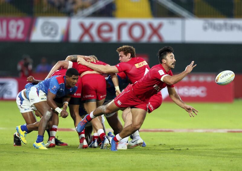 Dubai, United Arab Emirates - December 05, 2019: Nathan Hirayama of Canada passes the ball during the game between Samoa and Canada in the mens section of the HSBC rugby sevens series 2020. Thursday, December 5th, 2019. The Sevens, Dubai. Chris Whiteoak / The National
