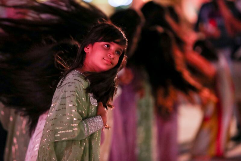 Young Emirati girl performing Al Ayyala traditional dance.