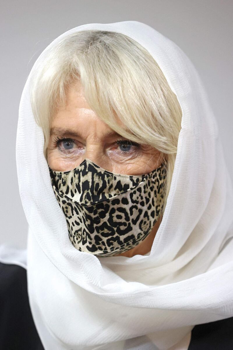 She covered her hair with a white headscarf and wore a leopard-print face mask for the visit. AFP