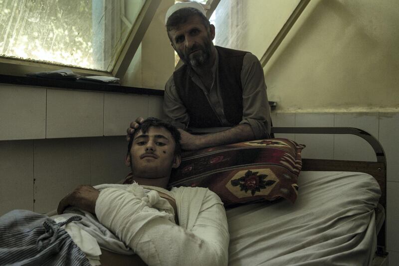Erfan Kamal, 18, had been working as a pine nut farmer for just a day when the drone struck. In hospital in Jalalabad, he's waiting to find out how and where he can undergo head surgery. The blast fractured his skull and additionally burned his arm and leg. His father, Mohammed Hassan, 40, sits by his side. 