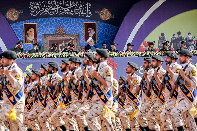 A handout picture provided by the Iranian presidency on September 22, 2019 shows President Hassan Rouhani (C) and other top military commanders watching members the Islamic Revolutionary Guard Corps (IRGC) marching past during the annual "Sacred Defence Week" military parade marking the anniversary of the outbreak of the devastating 1980-1988 war with Saddam Hussein's Iraq, in the capital Tehran. - Rouhani said on September 22 that the presence of foreign forces creates "insecurity" in the Gulf, after the US ordered the deployment of more troops to the region. "Foreign forces can cause problems and insecurity for our people and for our region," Rouhani said in a televised speech at the annual military parade, adding that Iran would present to the UN a regional cooperation plan for peace. (Photo by - / Iranian Presidency / AFP) / === RESTRICTED TO EDITORIAL USE - MANDATORY CREDIT "AFP PHOTO / HO / IRANIAN PRESIDENCY" - NO MARKETING NO ADVERTISING CAMPAIGNS - DISTRIBUTED AS A SERVICE TO CLIENTS ===