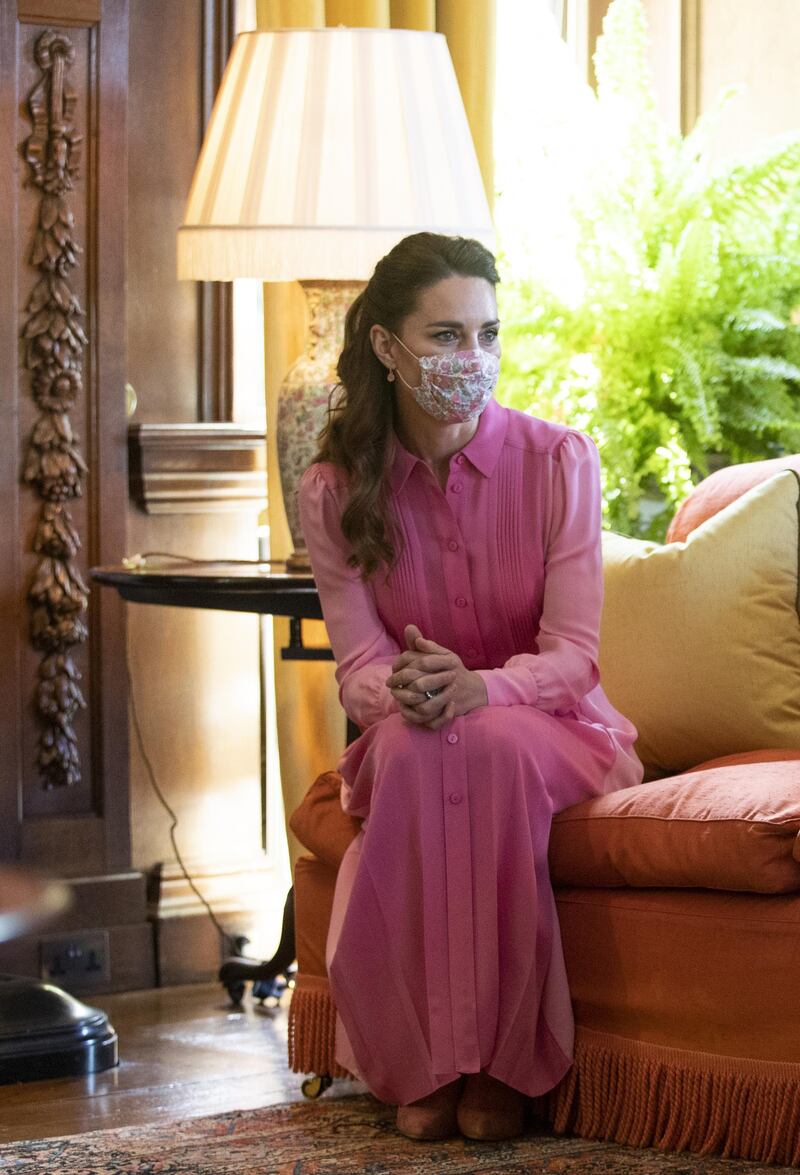 Kate Middleton wears a pink flowing dress to meet Mila Sneddon and her family at the Palace of Holyroodhouse . .Photo by Jane Barlow - WPA Pool/Getty Images.