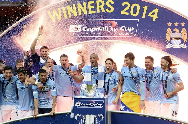 Manchester City players celebrate winning the League Cup final. Still alive in the Premier League title race, Champions League and FA Cup, City are hoping to complete a 'quadruple' this season. Facundon Arrizabalaga / EPA