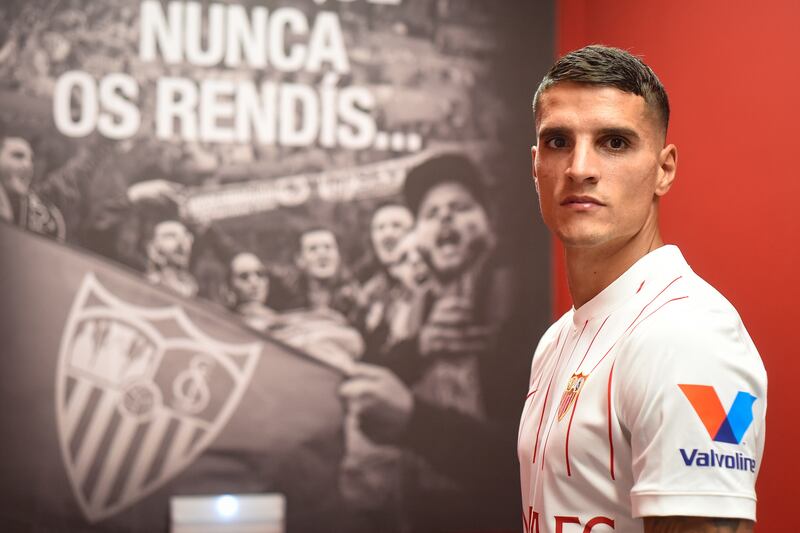 A handout photo made available by Sevilla Footbal Club show Erik Lamela posing in a team strip after signing from Tottenham.