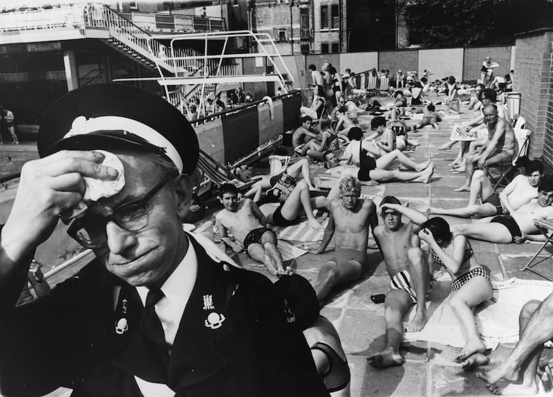 An ambulance man on duty at the Holborn Oasis swimming pool in London, in 1964.