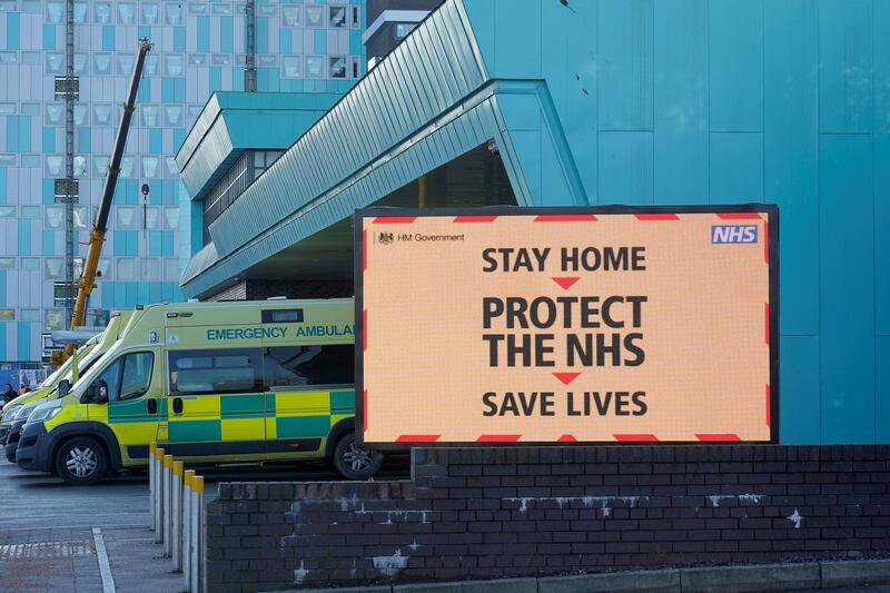 LIVERPOOL, UNITED KINGDOM - JANUARY 05:  Ambulances line up as a electronic sign funded by the trust gives out coronavirus pandemic information to visitors and staff at the Aintree University Hospital on January 05, 2021 in Liverpool, United Kingdom. British Prime Minister Johnson made a national television address on Monday evening announcing England is to enter its third coronavirus lockdown within a year. On Monday the UK recorded more than 50,000 new confirmed Covid cases for the seventh day in a row.  (Photo by Christopher Furlong/Getty Images)