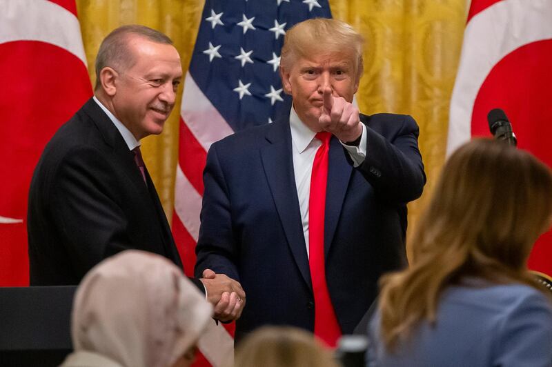 epaselect epa07994088 US President Donald J. Trump (R) and Turkish President Recep Tayyip Erdogan (L) finish a joint press conference in the East Room of the White House in Washington, DC, USA, 13 November 2019. The visit comes one month after Turkey's invasion into northern Syria against the Kurds and on the first day of public impeachment hearings.  EPA/ERIK S. LESSER