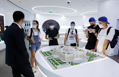 Visitors looking at the model of the Scientific Educational Centre, which will be completed in 2022, at the Uzbekistan pavilion. Pawan Singh/The National