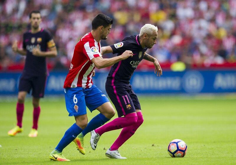 Neymar, right, scored twice to help Barcelona secure a 5-0 win against Sporting Gijon. Juan Manuel Serrano Arce / Getty Images
