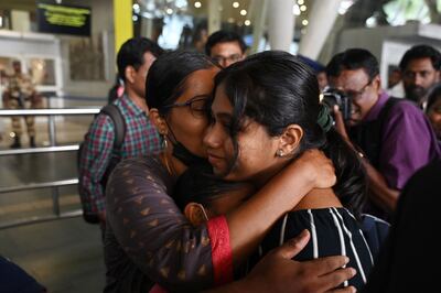 An Indian citizen who was stranded in Sudan is embraced by a relative at Chennai Airport on Thursday. AFP