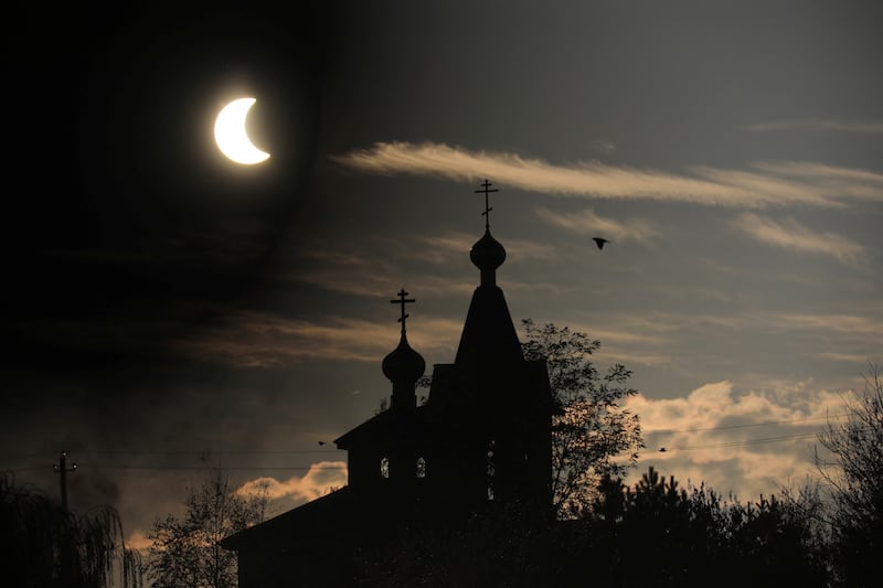 A partial solar eclipse over a Christian church in the Almaty region of Kazakhstan. Reuters