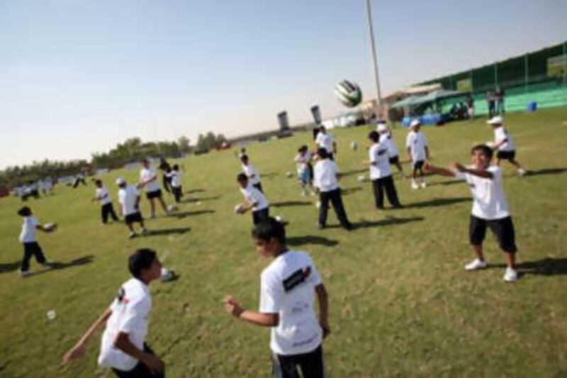 Regular physical activity is one of the best ways parents can prevent their children from becoming obese. These youngsters are practising their rugby skills in Abu Dhabi.