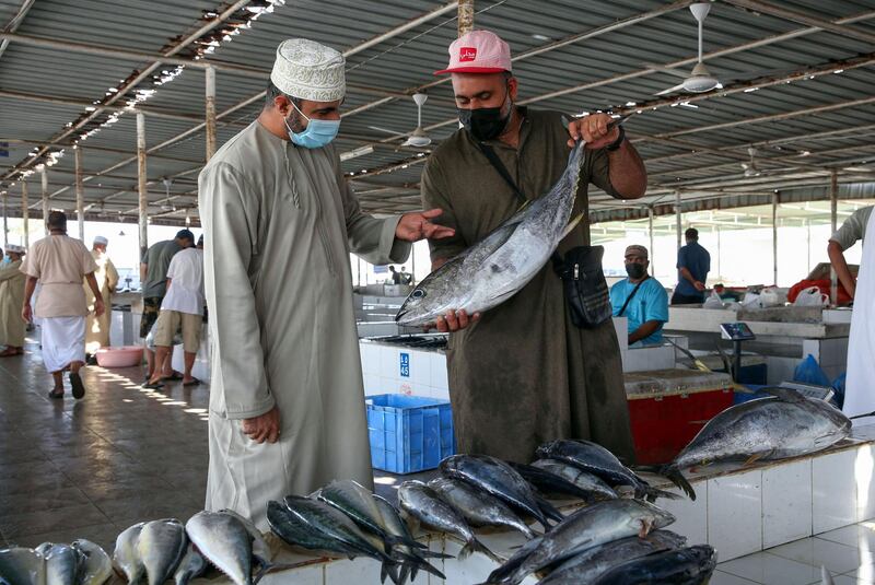 A man buys fish at the Al Seeb market in Oman's capital Muscat as people go on a shopping spree before the announcement of Ramadan. AFP