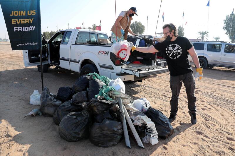 SHARJAH, UNITED ARAB EMIRATES , January 16– 2021 :- Members of the off roaders club unloading the trash during the desert clean up drive at the Al Badayer desert area in Sharjah. (Pawan Singh / The National) For News/Stock/Online/Instagram/Standalone/Big Picture. Story by Nick Webster