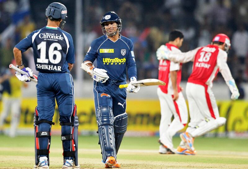 Deccan Chargers' Kumar Sangakkara, second left, walks back to the pavilion after being dismissed during an Indian Premier League cricket match against Kings XI Punjab in Hyderabad, India, Saturday, April 16, 2011. (AP Photo/Mahesh Kumar A.)