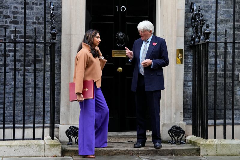 Home Secretary Suella Braverman speaks to Andrew Mitchell, Minister for Development and Africa. AP