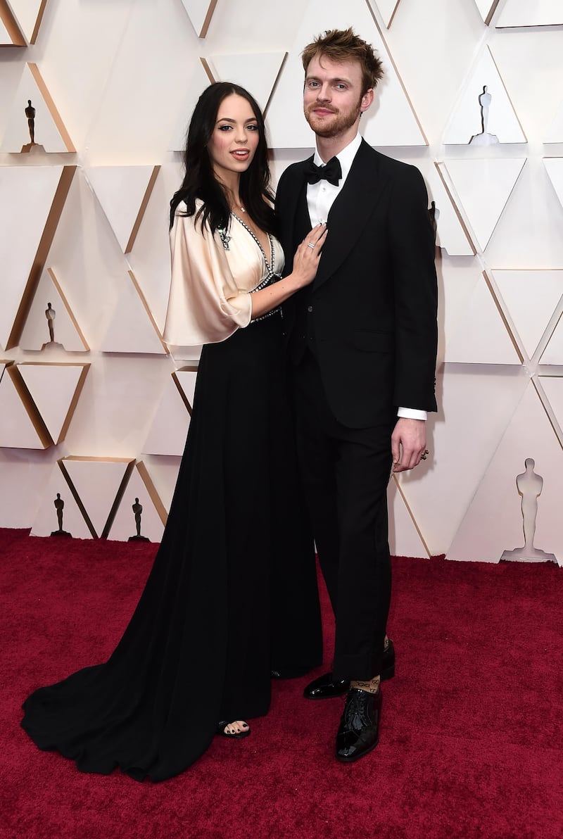 Claudia Sulewski and Finneas O'Connell arrive at the Oscars on Sunday, February 9, 2020, at the Dolby Theatre in Los Angeles. AP