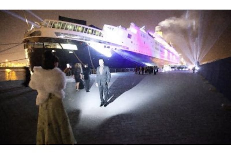 Guests take a picture before boarding the QE2 for its New Year's Eve party on Saturday night. Jaime Puebla / The National