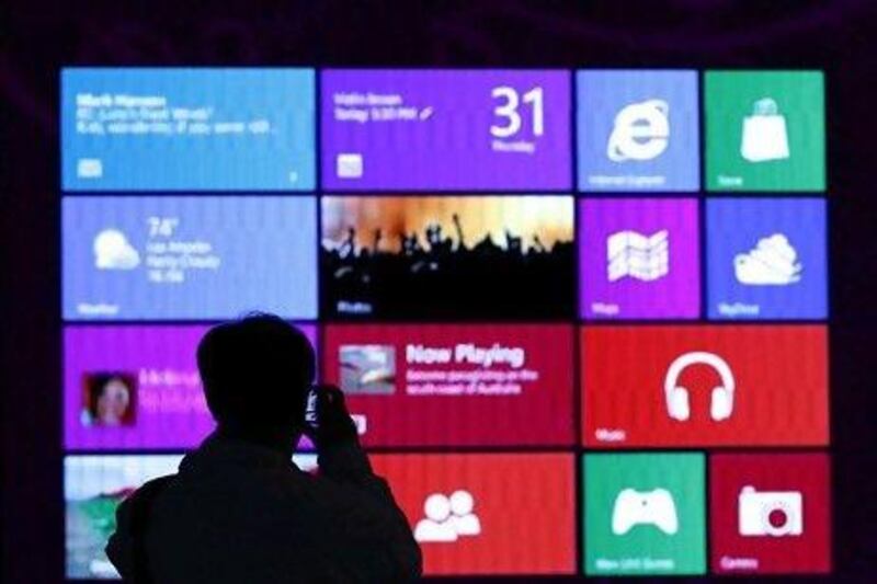 A man takes pictures at a Windows 8 promotion in Tokyo. The system has been described as faster and more secure than its predecessors. Toru Hanai / Reuters