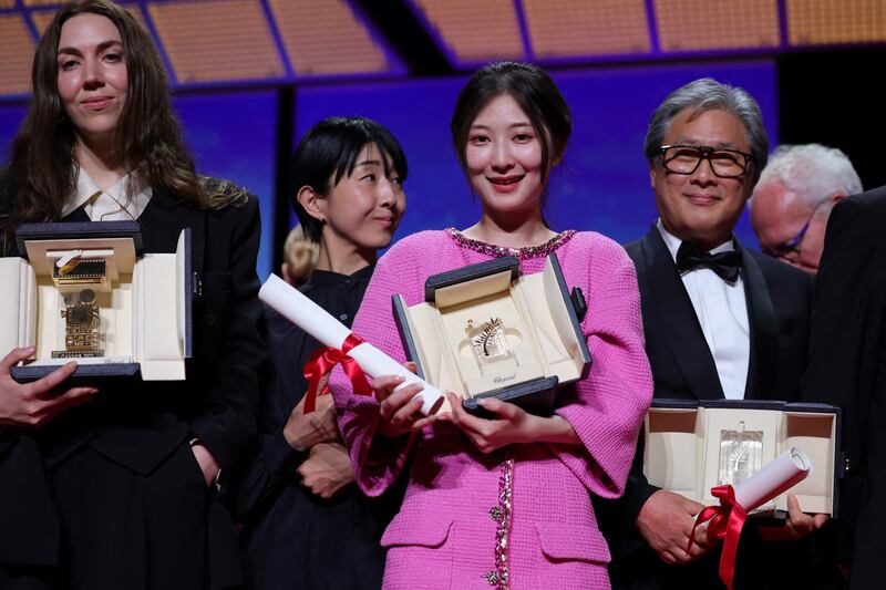 From left, Cannes Film Festival 2022 winners, British director and screenwriter Gina Gammell, Chinese director Jianying Chen and South Korean actor Park Yong-woo, at the closing ceremony. AFP