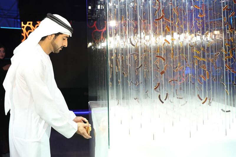 Sheikh Hamdan affixes a plaque onto artwork by Thomas Medicos which was inspired by the Expo 2020 logo. Wam