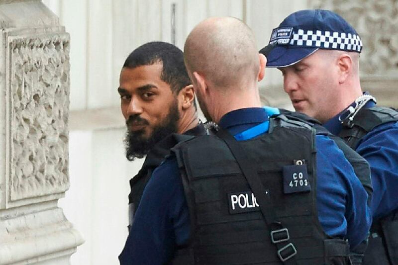 (FILES) In this file photo taken on April 27, 2017 firearms officiers from the British police detain a man, later named as Khalid Mohammed Omar Ali, on Whitehall near the Houses of Parliament in central London. Khalid Ali, a plumber has been jailed for life on July 20, 2018 for planning a terror attack in Westminster and making bombs for the Taliban.
 / AFP / Niklas HALLE'N
