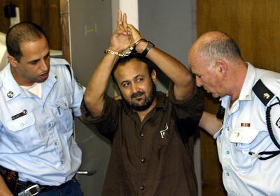 FILE PHOTO: Marwan Barghouti, a popular Palestinian leader, gestures as Israeli police bring him into the District Court for his judgment hearing in Tel Aviv May 20, 2004.  REUTERS/Pool/David Silverman/File Photo