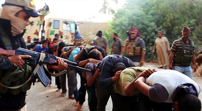 A picture posted by the Islamic State of Iraq and the Levant (ISIL) website shows its militants leading away captured Iraqi soldiers dressed in plain clothes after taking over a base in Tikrit, Iraq. The Islamic militant group that seized much of northern Iraq has posted photos that appear to show its fighters shooting dead dozens of captured Iraqi soldiers. (AP Photo via militant website)
