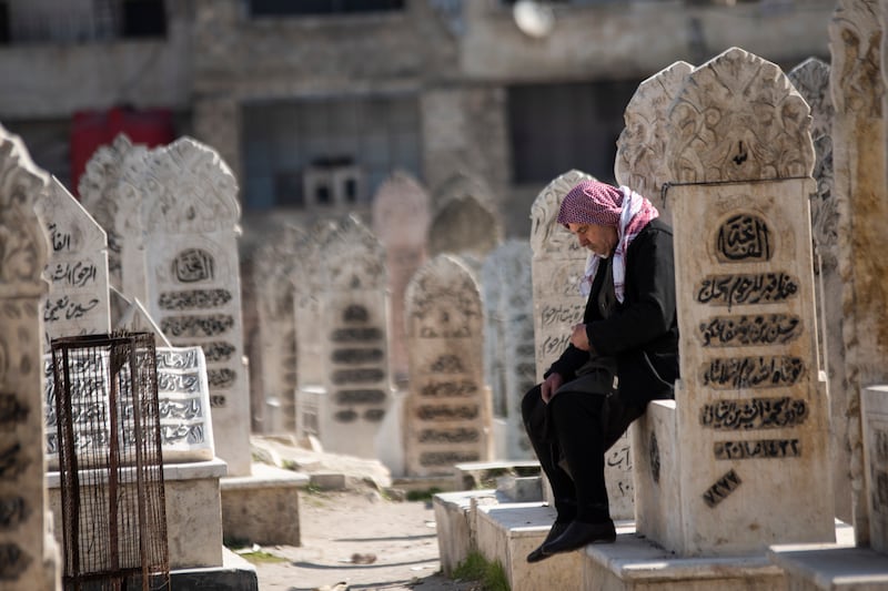 A grieving man, who lost family members to the earthquake, in the graveyard in Aleppo. All photos: Hasan Belal for The National
